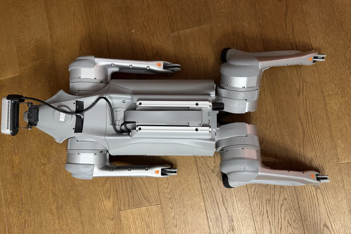 A real photo of our robot from above, lying flat and still on a wooden floor, with the computer that runs Cereal OS on its back